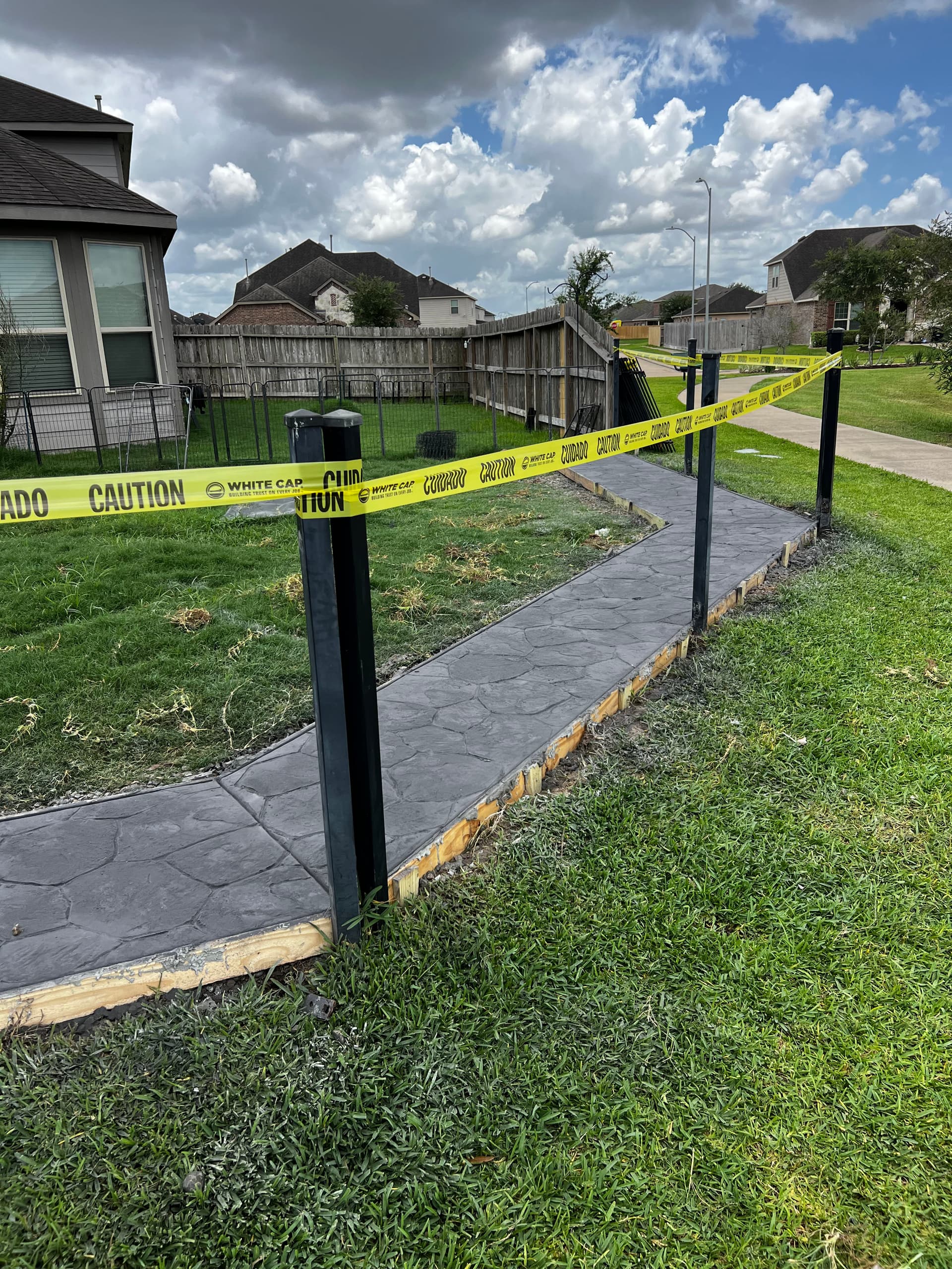 Gallery photos for Stamped Concrete Walkway That Stopped a Dog From Digging Under the Fence: Image #6