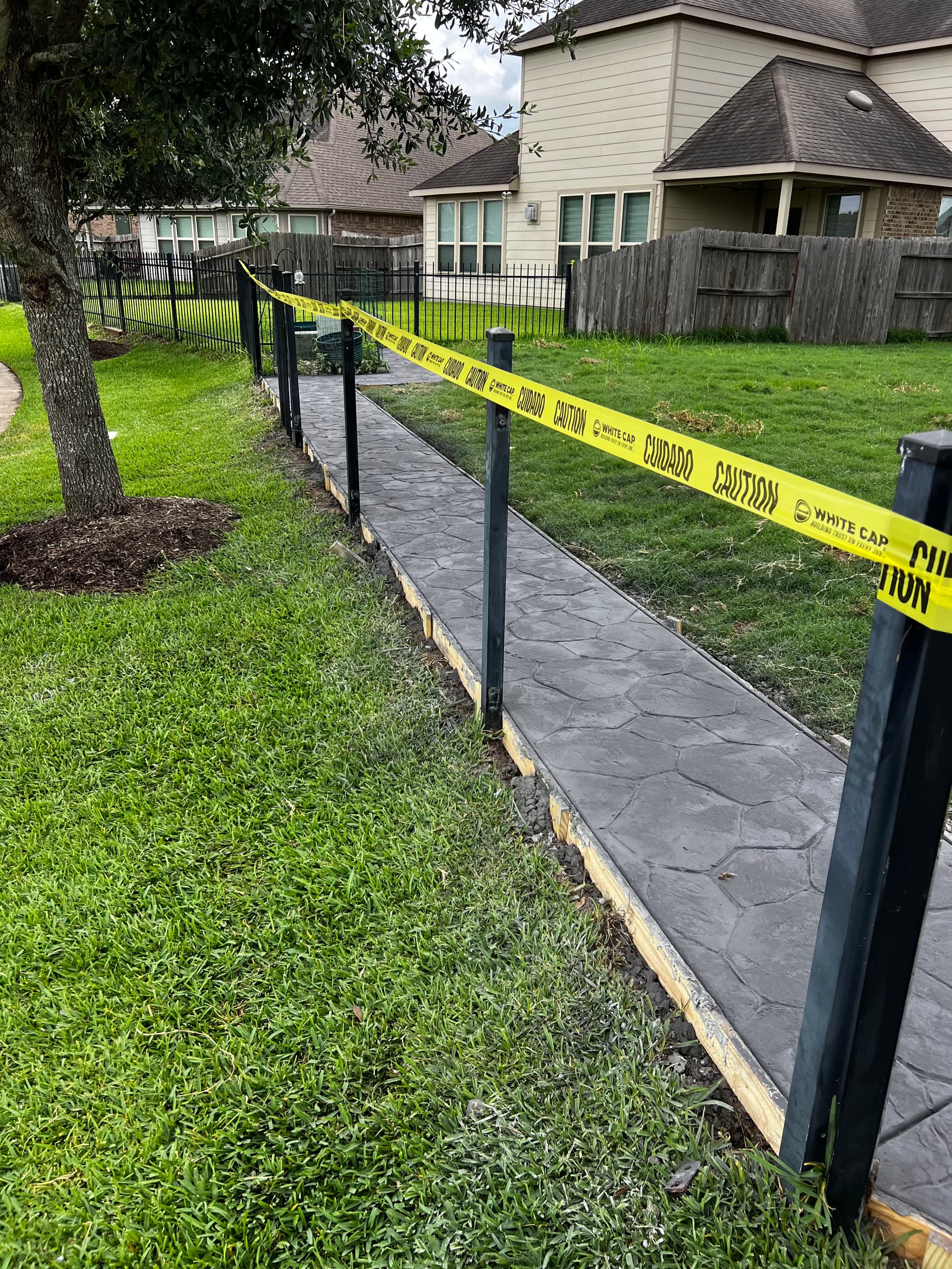 Gallery photos for Stamped Concrete Walkway That Stopped a Dog From Digging Under the Fence: Image #5