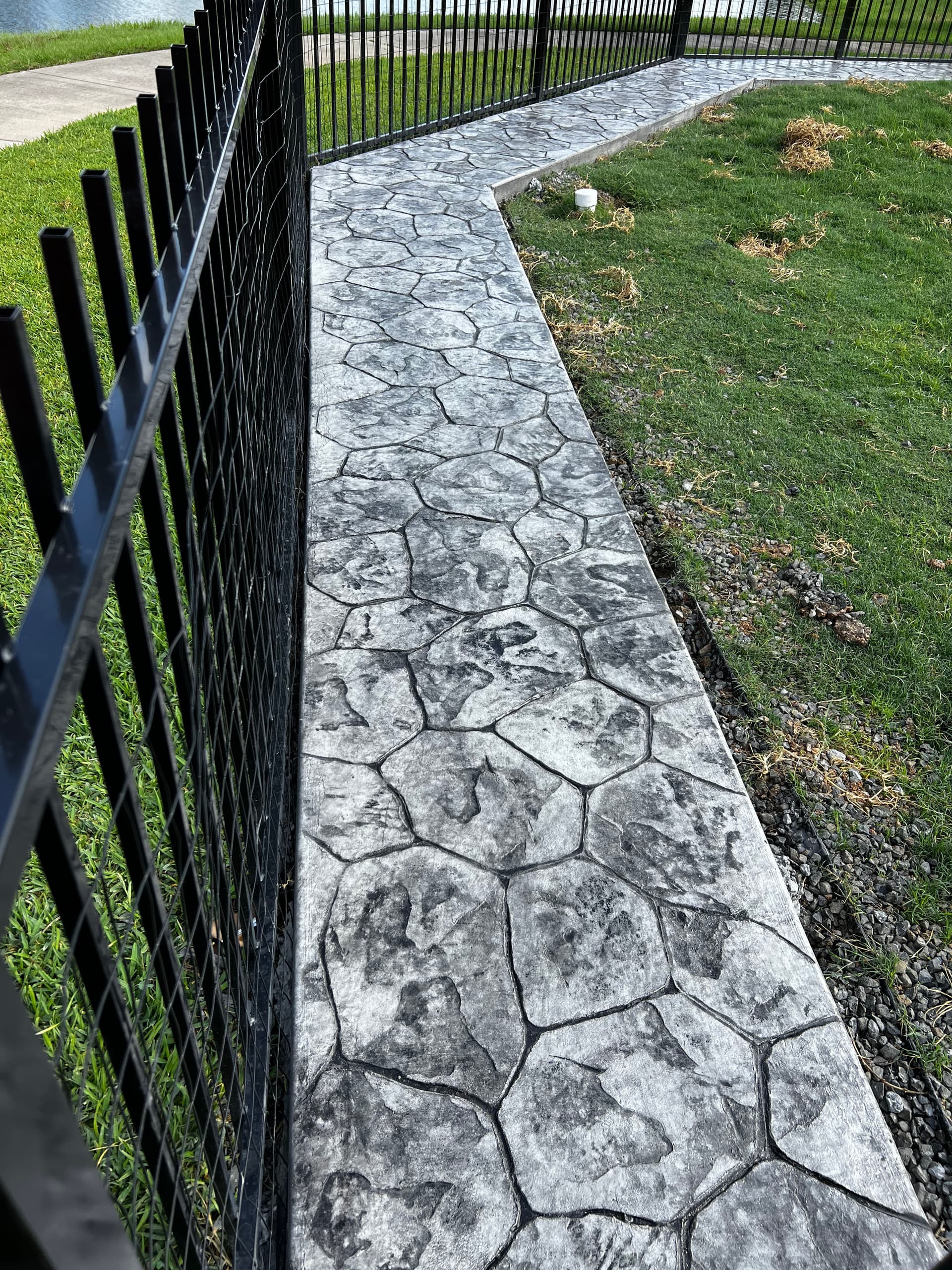 Stamped Concrete Walkway That Stopped a Dog From Digging Under the Fence image